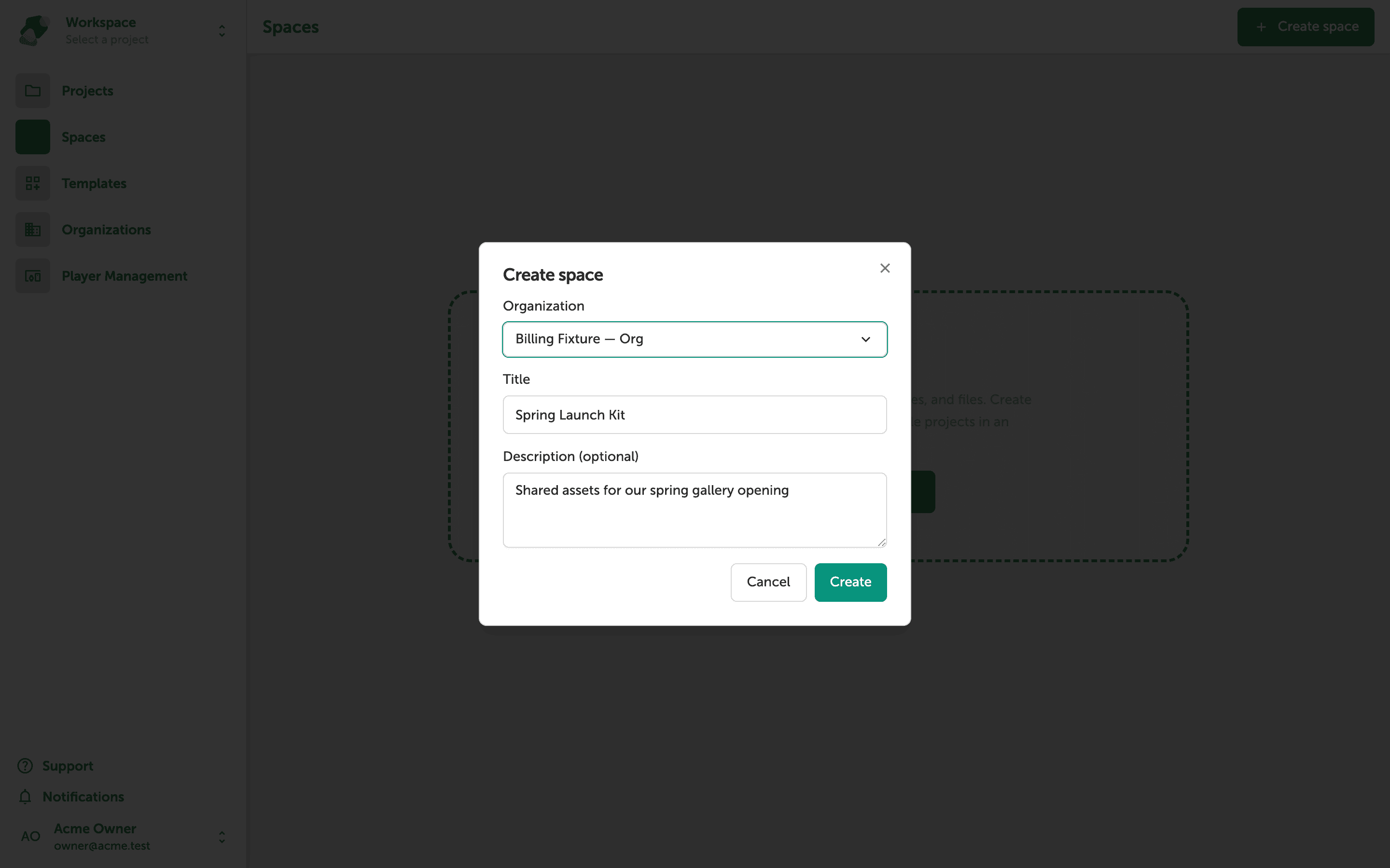 A modal dialog titled Create space with an Organization dropdown set to an Organization-plan workspace, a Title field containing Spring Launch Kit, and a Description field containing Shared assets for our spring gallery opening. Cancel and Create buttons appear at the bottom.